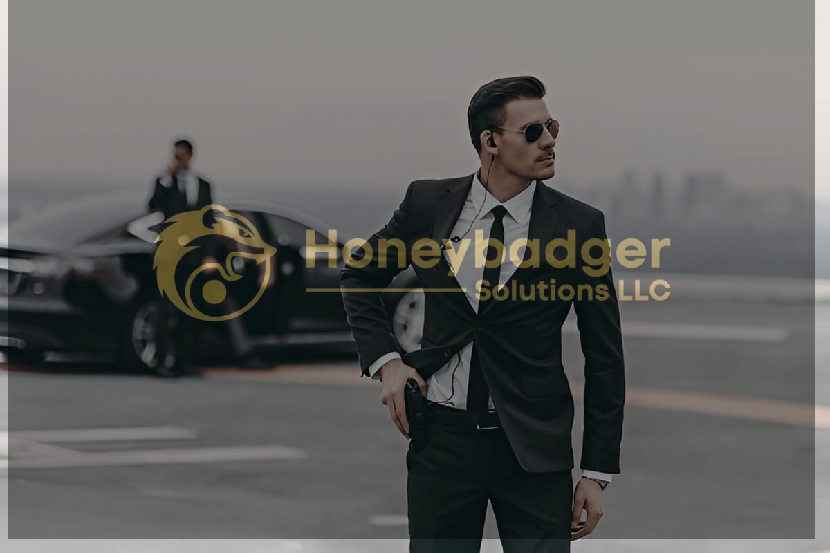 Two men in black suits and sunglasses stand near a black car; one talks on an earpiece, while the other stands alert with a hand near his waist.