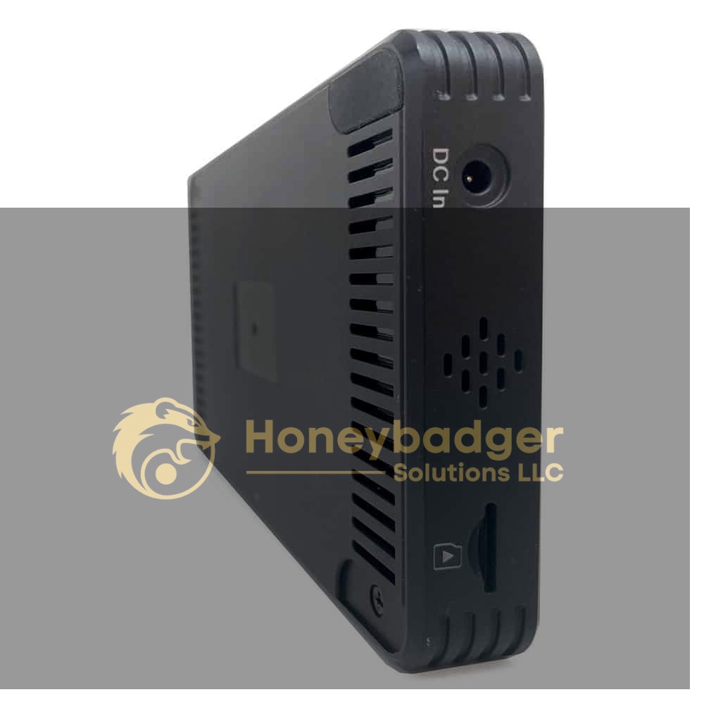 A side view of a DVR featuring a DC in port, vent, memory card slot, and small speaker grill.