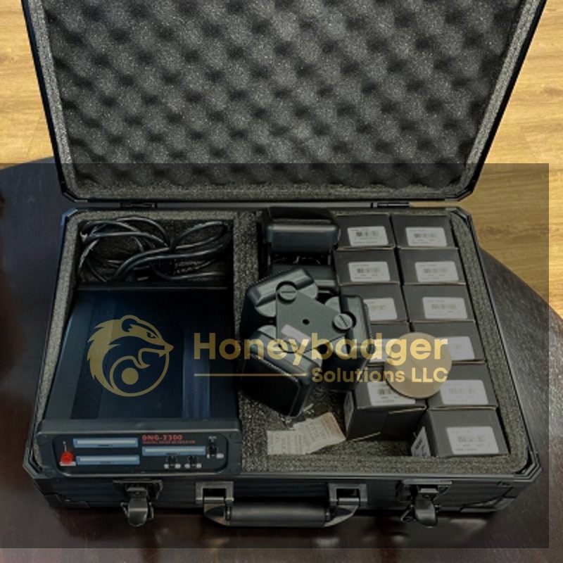 A black hard case containing a DHC-7300 device, cables, and labeled boxes for digital forensics.