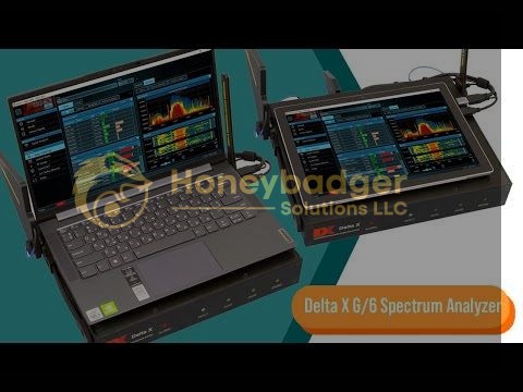 Two laptops connected to a Delta X Portable Real-time Spectrum Analyzer 6Ghz, displaying spectrum analysis software.