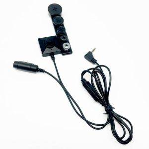 Wired covert button camera with a long black cable and 3.5mm audio jack for audio connections.