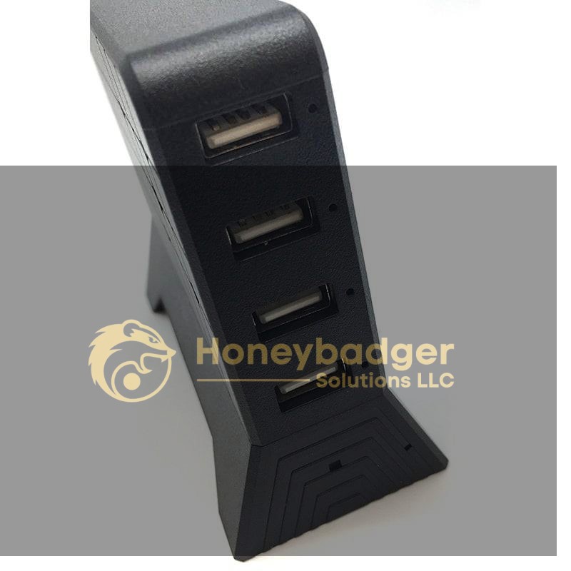 A black USB charging station with four front-facing USB ports for device connectivity.