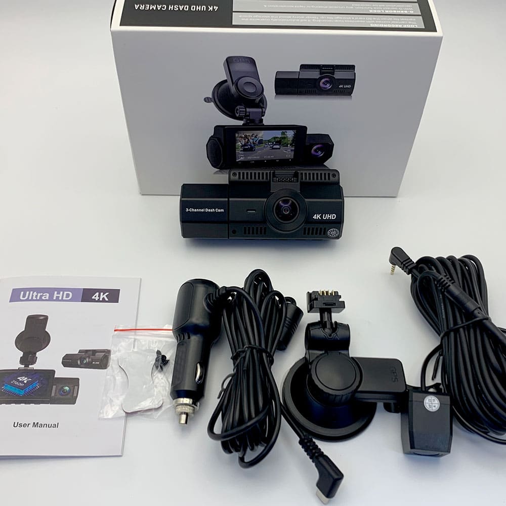 4K Dual Dash Cam displayed with user manual, power adapter, suction mount, and cables on a white surface.