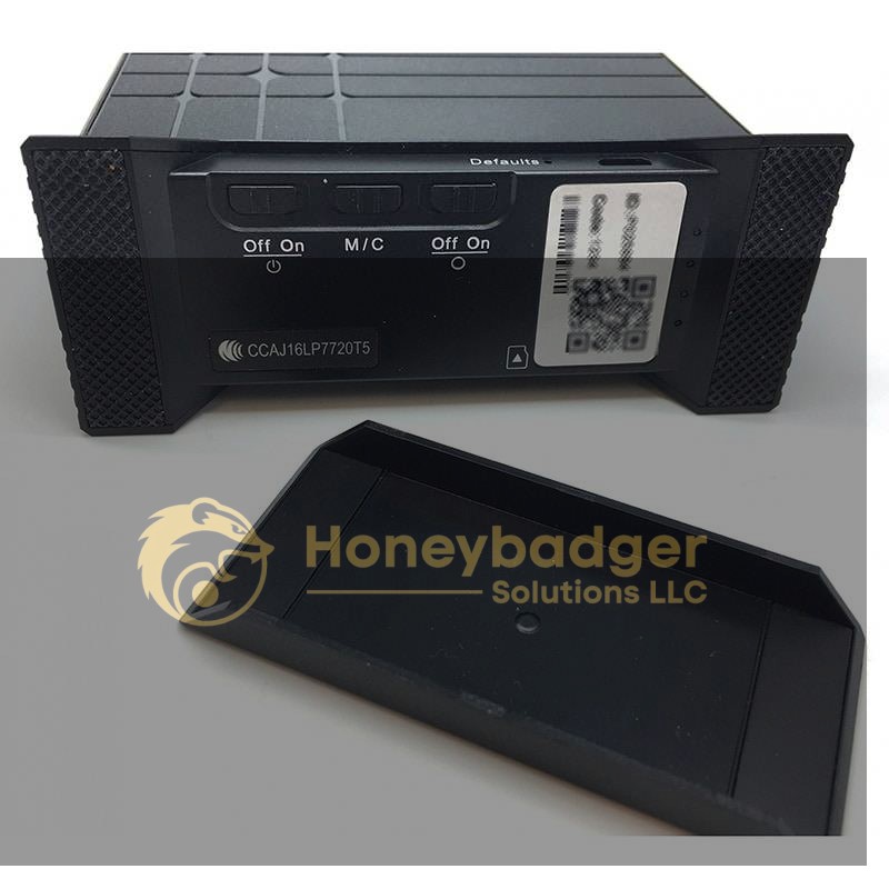 Close-up view of a USB charging station hidden DVR camera with three labeled switches and a QR code sticker visible.
