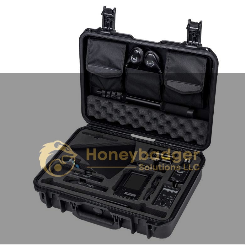 Black hard-shell equipment case containing various electronic devices and accessories organized in compartments.