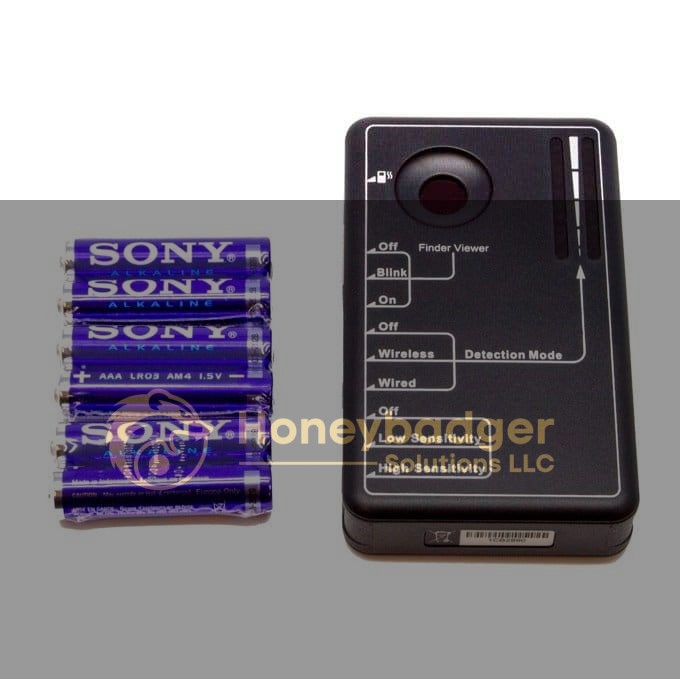 LawMate Pocket RF Detector, a black electronic device, alongside four blue Sony AAA alkaline batteries on a white background.