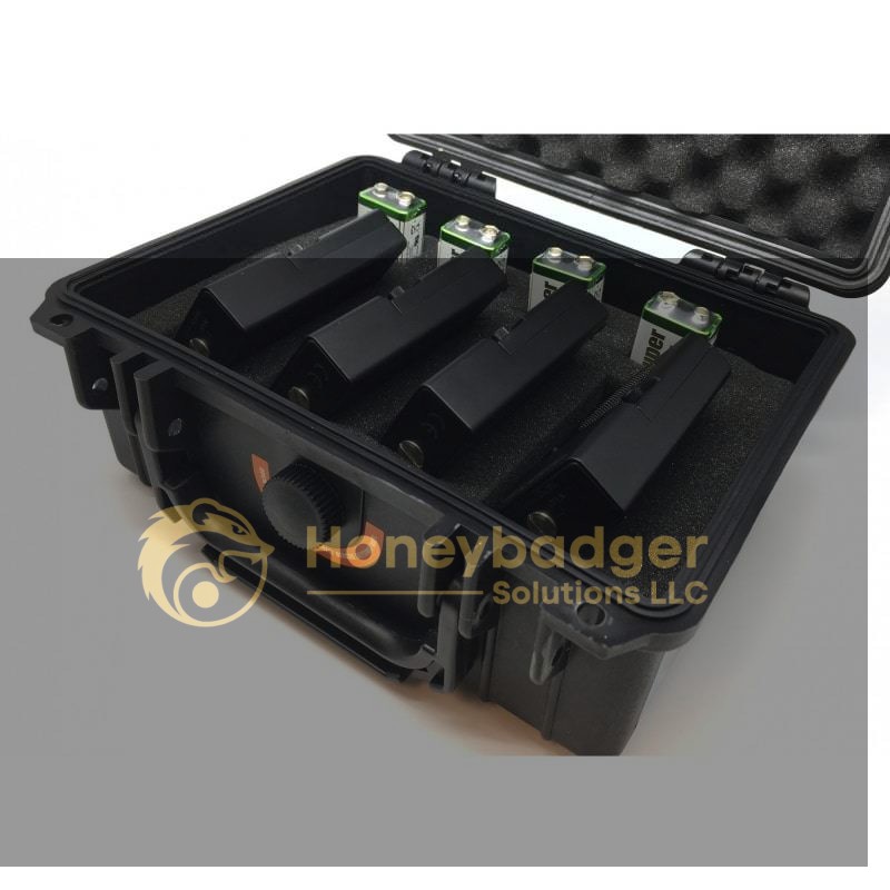 Rabbler Noise Generator Kit in a black hard case containing four black battery packs with green and silver terminals.