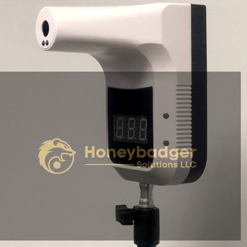 An infrared thermometer displaying an 8.8.8 reading, mounted on a black tripod stand.