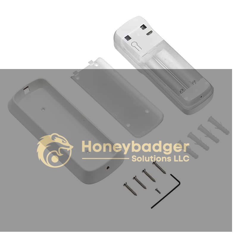 A disassembled SleuthGear Wi-Fi home security remote case with battery compartment, screws, wall plugs, and an L-shaped hex key arranged neatly.