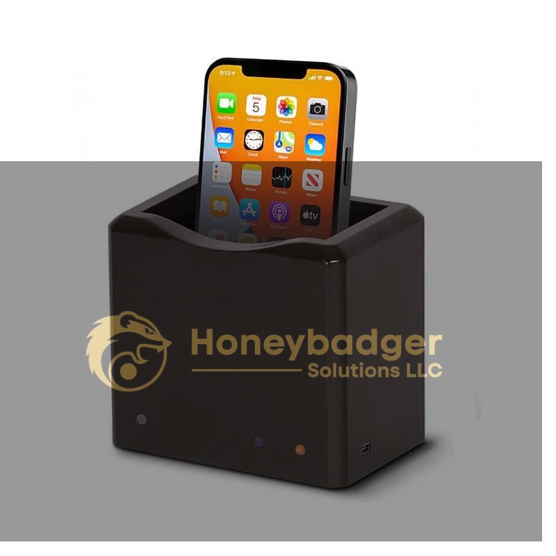 Phone Safe Ultra - NG4100, a dark rectangular device with indicator lights and a side USB port, holds a smartphone vertically inside it.