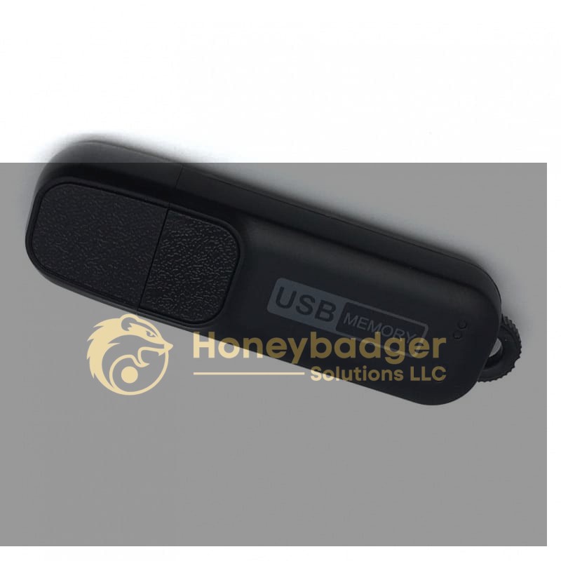A black USB Stick Voice Recorder labeled 'USB MEMORY' with a protective cap for discreet audio recording.