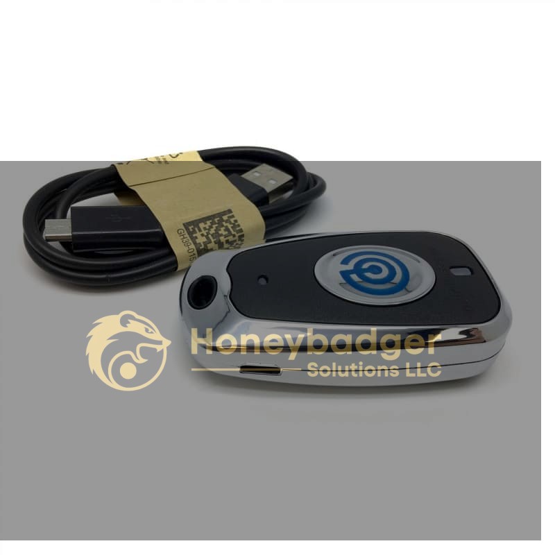 DeScammer Credit Card Skimmer Detector in black and silver next to a black USB charging cable with a micro USB connector.