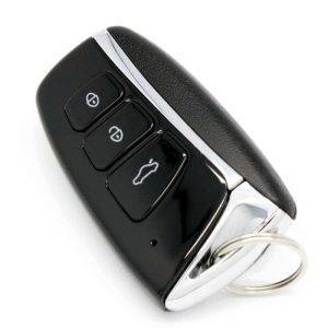 A black and silver key fob featuring three functional buttons and a keyring attachment.