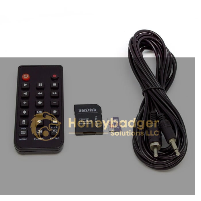 Remote control, SanDisk microSD card with adapter, and a long audio cable with two RCA connectors on a white background.
