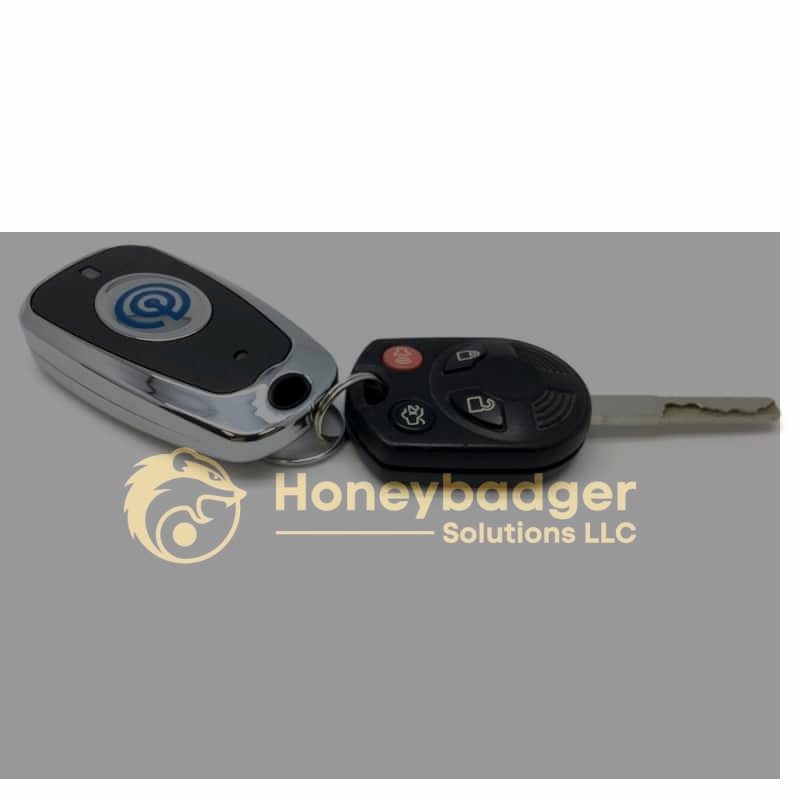 A car key fob with buttons for locking and unlocking, attached to a metal key.