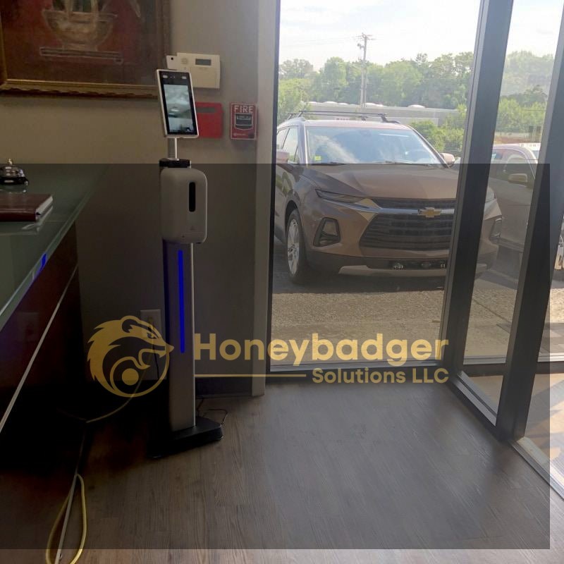 TMT2 Camera with a 4 ft stand and hand sanitizer set positioned near a glass door.