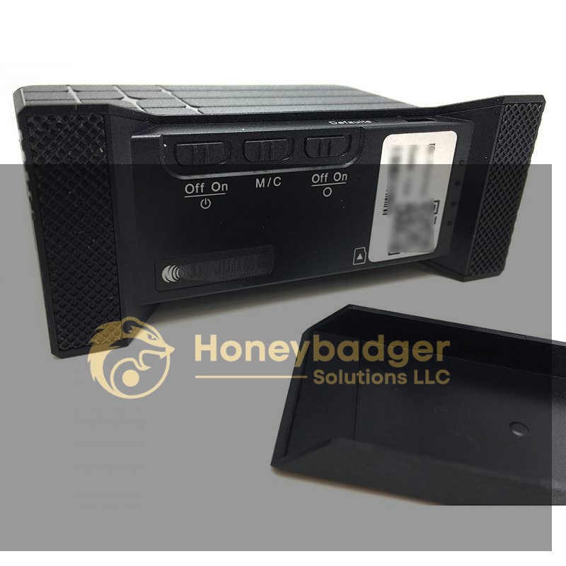 A black USB charging station with three labeled switches, a card slot, and a removable cover, used for discreet monitoring.