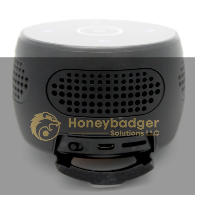 Rear view of a Bluetooth speaker hidden camera showing speaker grille, micro USB port, and microSD card slot.
