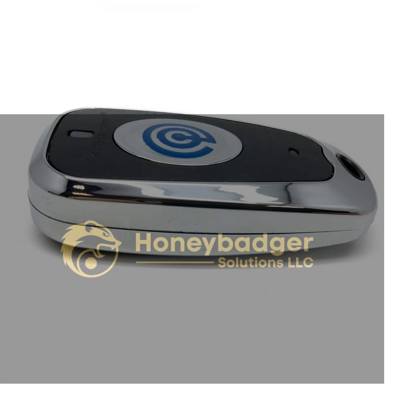 A close-up view of a Credit Card Skimmer Detector with a sleek design, silver edge, and blue circular logo on a black center.