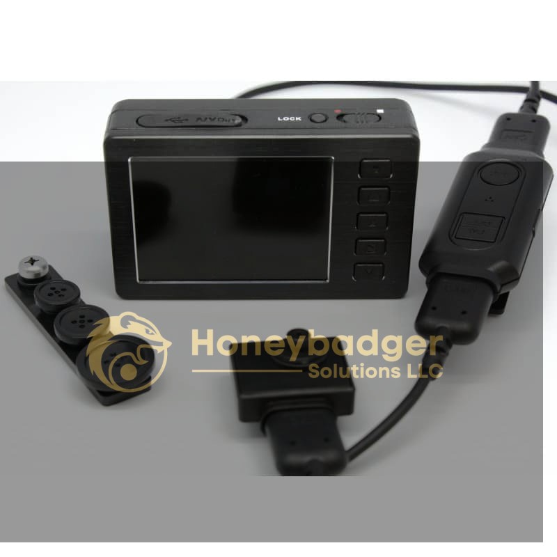Compact black HD DVR with a screen and control buttons, wired to a remote unit and small cameras, including a button-shaped camera.