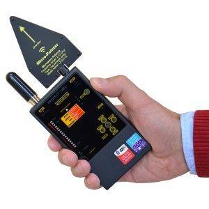 A person holds an iProtect Digital RF Detector, a black handheld device with a display screen, buttons, and a triangular antenna.