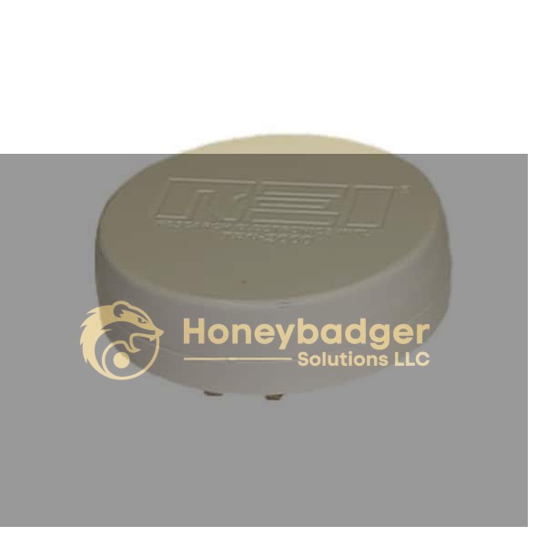 A compact, round white plastic Acoustic Noise Generator with a raised top and embossed logo, featuring small metal contacts underneath.
