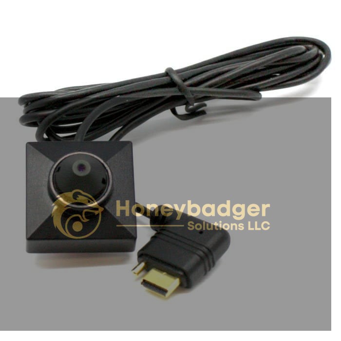 Compact black spy camera with a square housing, central lens, and long coiled cable ending in a right-angle connector.