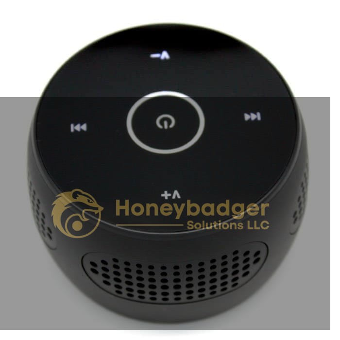 Black Bluetooth speaker featuring a circular touch control panel and perforated grille for sound output.