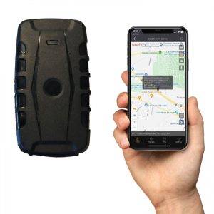 A hand holds a smartphone displaying a map app next to the iTrail Endurance GPS Tracker with a black textured design.