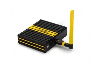 A compact black and yellow Firewalla Wi-Fi SD device with ridged sides and a yellow antenna attached.