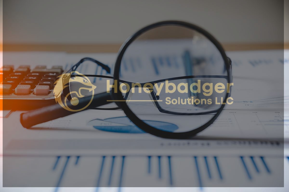 A magnifying glass and eyeglasses placed on financial documents with charts and graphs, alongside a calculator.
