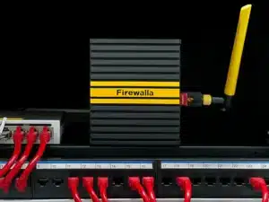 Firewalla Wi-Fi SD device with a yellow stripe and external antenna connected to a network switch via red Ethernet cables.