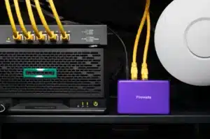 A network setup featuring a black server and a purple Firewalla device with yellow Ethernet cables connected.