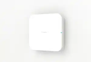 A compact, white Firewalla Access Point 7 Ceiling with rounded corners and a subtle blue light mounted on a white wall.