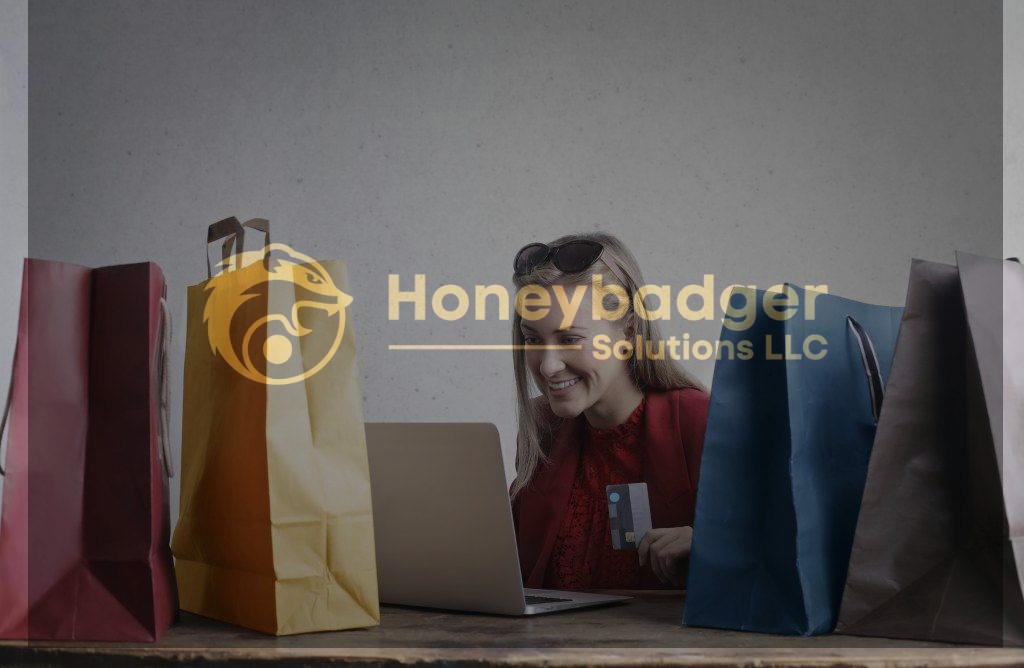 A woman smiling while shopping online with a laptop and colorful shopping bags around her.