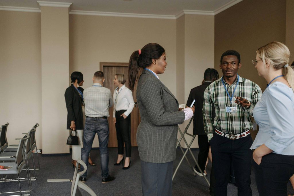 Group of business professionals interacting during a corporate event in a conference room.