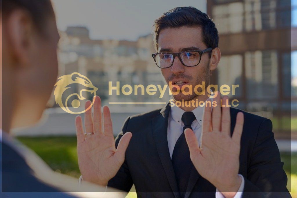 Businessman in a suit and glasses gesturing with hands in a conversation outdoors.