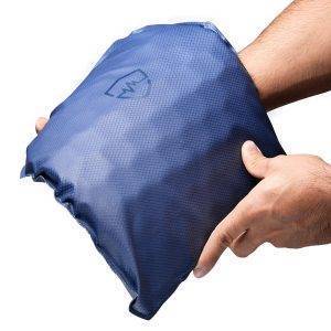 A blue FRAS™ rifle armor panel is held in both hands, showing its flexible shape and textured surface against a white background.