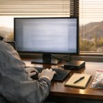 Forensic examiner capturing website evidence for court with a laptop and evidence drive