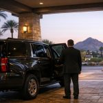 Security driver services: a protective driver beside an SUV at an Arizona hotel entrance
