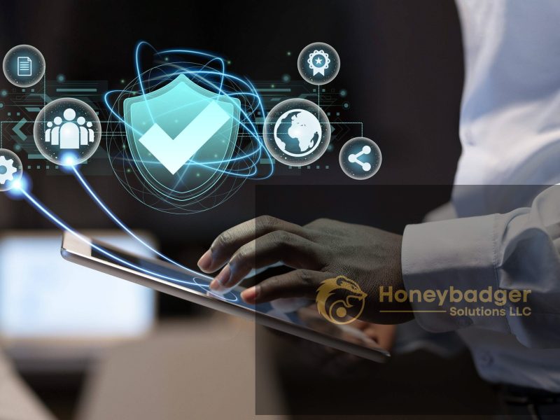 A person in a white shirt interacts with a tablet displaying digital security icons, including a shield and gears, representing cybersecurity.